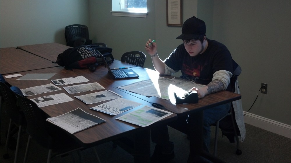 UNE intern Dean Smalley researching fire history for a new online exhibit. 